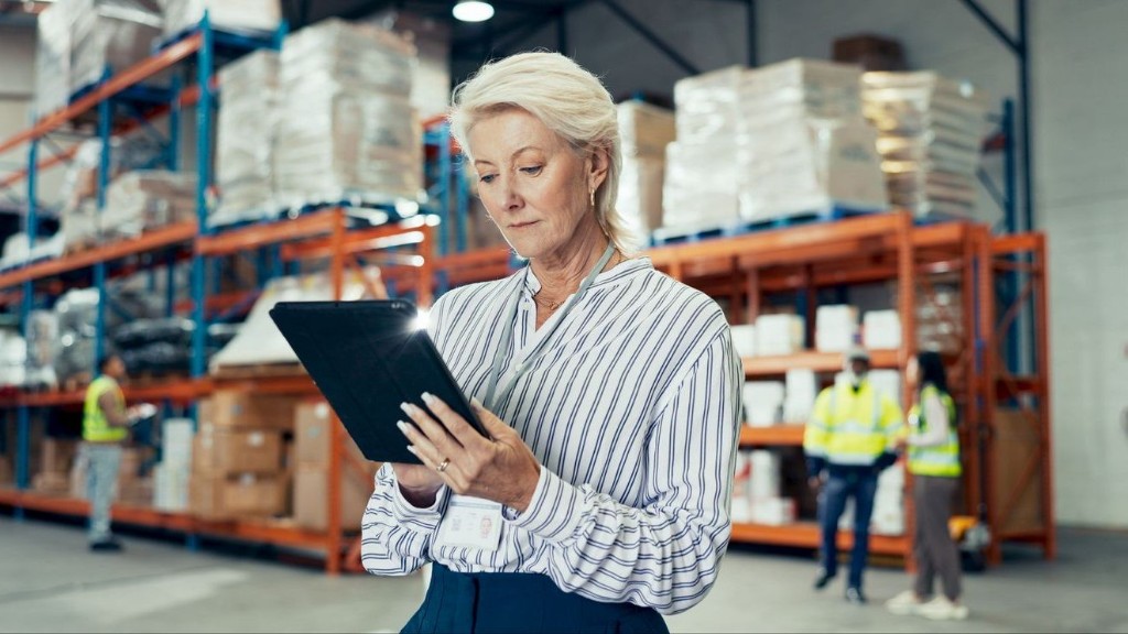 Operations manager reviewing warehouse data on a tablet